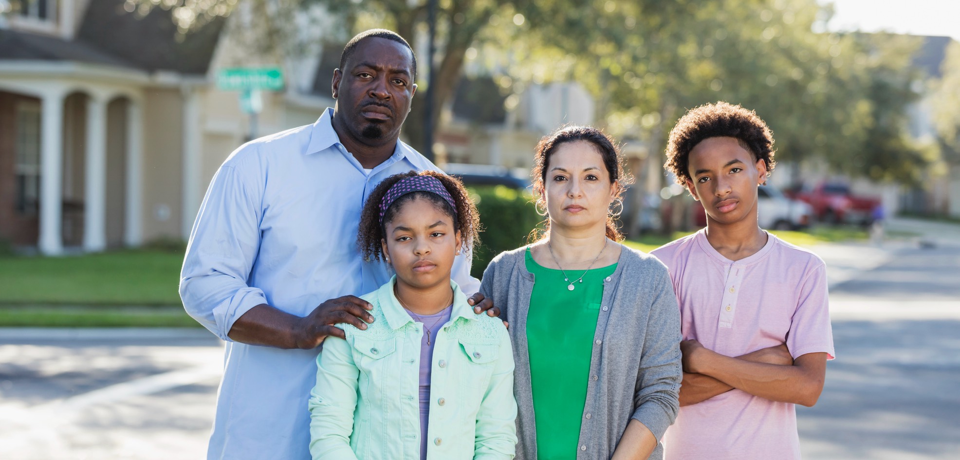 Multiracial family on residential street.